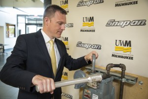 Andy Lobo, director of product management and development at Snap-on Inc., demonstrates an ergonomic wrench designed at UWM. The wrench sold by Snap-on will reduce injuries among workers in the gas utility industry.