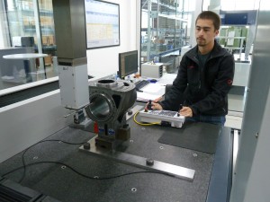 UW-Stout manufacturing engineering student Michael Guzman works with the Coordinate Measuring Machine at Fischer AG in Switzerland.  
