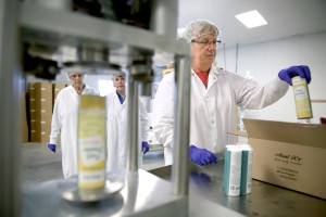 Peggy Krueger, right, boxes sealed containers of Aunt K’s at CTL Foods in Colfax. Looking on are Aunt K’s owners Sharon Horstman, left, and Kay Widule.