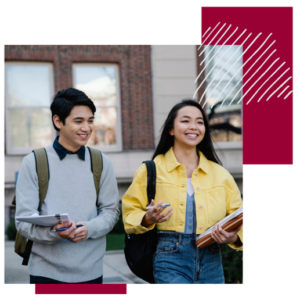 2 students carrying books and papers and walking side by side