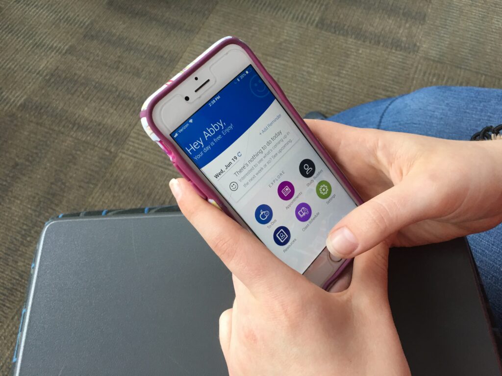 Navigate app on screen of cellphone held by student