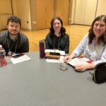 Three UW-Superior colleagues seated at a table at the UW System Navigate and Advising Workshop at UW-Stevens Point in March 2023.