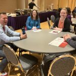 Billy Felz and John Reichert of UW-Eau Claire with two UW colleagues seated between them at the UW System Navigate and Advising Workshop at UW-Stevens Point in March 2023.