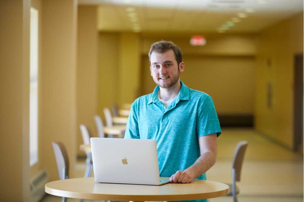 Photo of UW-La Crosse senior Kaelan Engholdt, who with the help of Assistant Professor David Mathias, has created an "extinction event" operator that allows computers to more effectively solve complex problems.