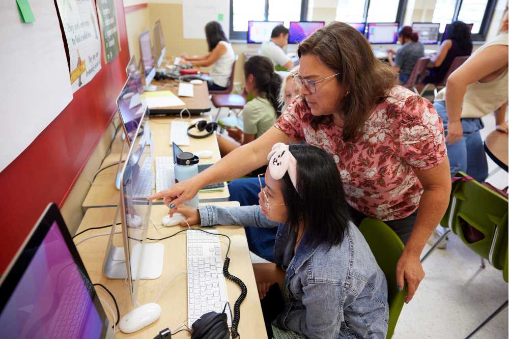 Photo of UW-La Crosse Professor of Educational Studies Heather Linville helping local middle school student Julia Bacalso on her digital storytelling project. Through the "We live in La Crosse: Stories of belonging" project, Linville hopes to amplify diverse voices in the La Crosse community.