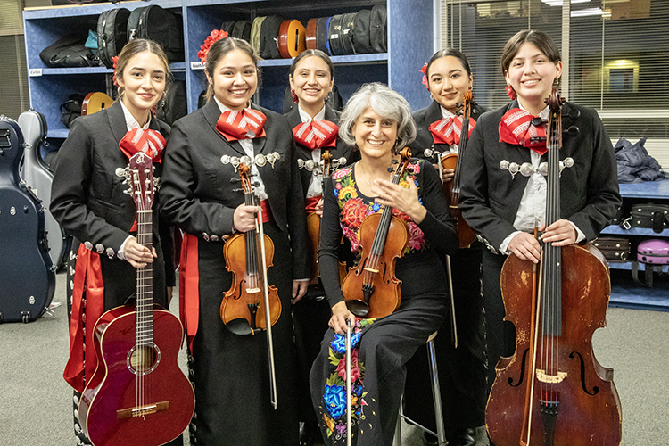 Photo of Dinorah Márquez Abadiano (center) posing with some of her students before a performance: Natali Rodriguez (from left), Zaara Bonilla, Lili Hernandez Dingel, Lucy Apolinar and Carolina Islas. (UWM Photo/Troye Fox)