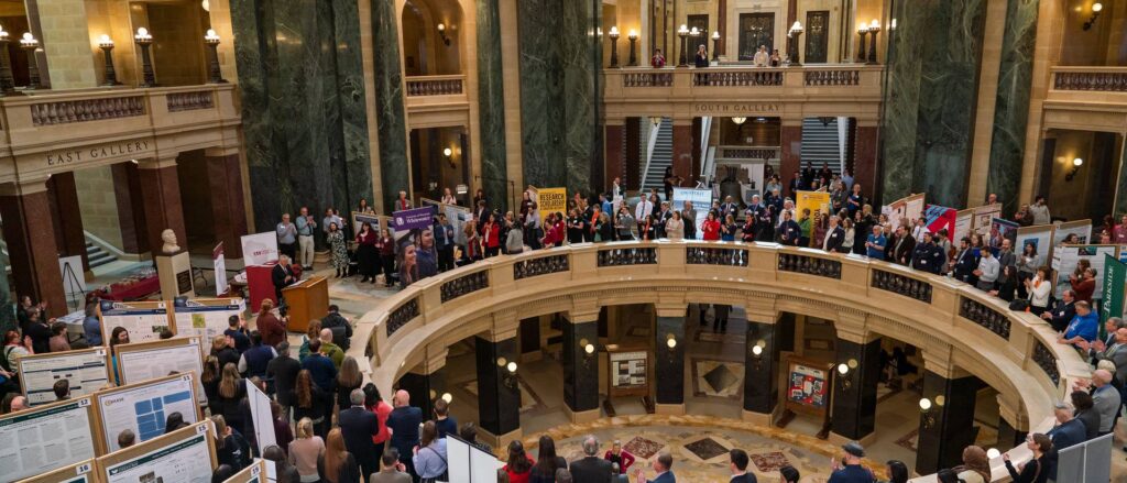 Photo of Research in the Rotunda student projects from a balcony: The annual Research in the Rotunda event highlights the UW System as a national leader in undergraduate research, contributing to the state’s priorities, including retention, graduation rates, workforce and economic development (photo by Shane Opatz, UW-Eau Claire).