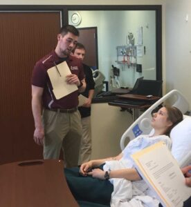 Photo of simulation: During the annual Interprofessional Model of Patient Care Training (IMPACT) UW-La Crosse and Viterbo University students take part in simulated case scenarios to develop confidence in advocating for their professional roles to meet a patient’s need.
