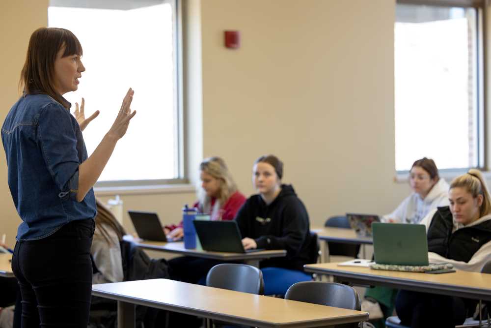 Photo of Prochazkova, who says: “After one month here, I could say that I love this place. People are so kind. My colleagues from the Department of Management are very supportive and sociable, and the students are curious and communicative.”