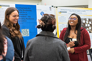 Photo of Kayla Jackson (right) and Sophia Santiago-Fodor presenting their research April 28 at the undergraduate research symposium. (UWM Photo/Elora Hennessey)