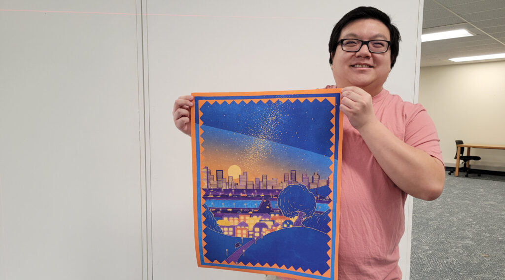 Photo of Jackson Yang with his favorite artwork from his master's thesis, 'A Thread through History,' displayed at the University Library Art Lab.