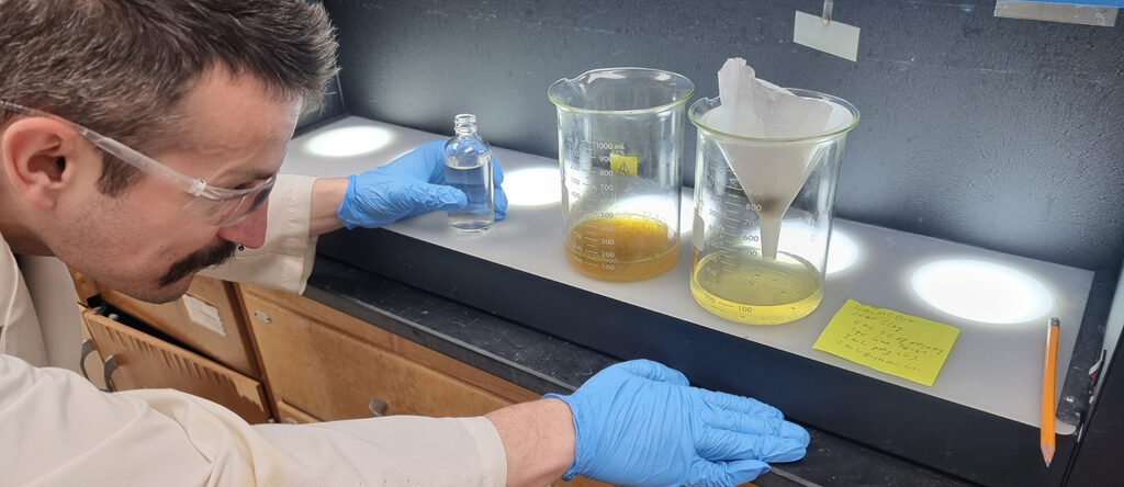 Photo of UW-Oshkosh student Tyler Peskie analyzing water samples for Sadoff Iron & Metal Company