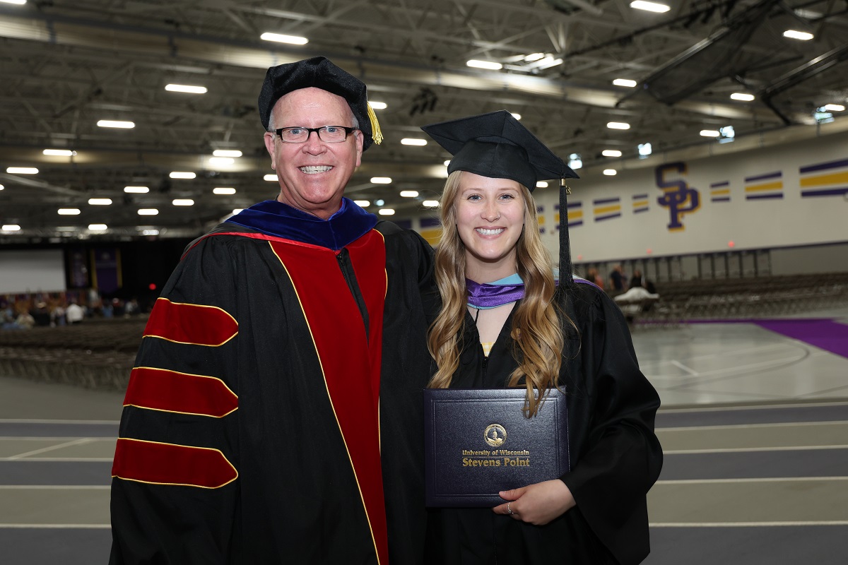 Photo of Perry and Stephanie Cook at the May 2025 commencement ceremony, where Perry was able to present his daughter with her diploma.
