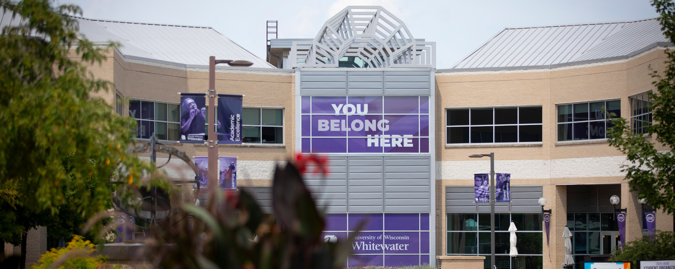 Photo of UW-Whitewater campus with sign: "You belong here."