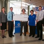 group holding a large check