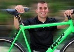 business owner posing with his single-speed bike