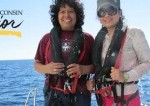 professor and student wear wet suits on a boat