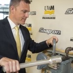 Andy Lobo, director of product management and development at Snap-on Inc., demonstrates an ergonomic wrench designed at UWM. The wrench sold by Snap-on will reduce injuries among workers in the gas utility industry.