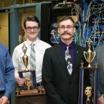 From left, UW-Stout students who placed in a national computer network design contest are Nathanael Satnik and Corey Schoff, third place; and Dan Schmidt and Brandon Wolf, first place. They hold their trophies in a computer networking lab in Fryklund Hall.