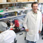 Jim Burritt, associate professor of biology, is photographed Tuesday, July 7, 2015 in a biotechnology lab in Jarvis Hall, while working with students and lab assistants on his two-year bee study project, "Honey Bee Hemocyte Profiling by Flow Cytometry". Burritt is trying to help figure out the problem known as hive winter kill, which is threatening the honeybee industry and possibly even the species itself. (UW-Stout photo by Brett T. Roseman)