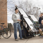 Dr. Kim Pierson, UW-Eau Claire professor of physics, discusses a solar-powered water heater he is developing with research students Brendon Kwick, Sawyer Buck and Hunter Hermes.