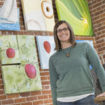 UW-Eau Claire alumnus Erin Klaus stands in the new location of Tangled Up In Hue, the art collective she and her business partner have operated in downtown Eau Claire since 2009. Klaus says her undergraduate experience at UW-Eau Claire was a big factor in the decision to start a business downtown, and the business has grown amid an overall revitalization of the area.