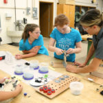 Kari Berthiaume helps STEPS for Girls participants with their robot projects in an engineering lab at UW-Stout.