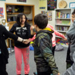 UW-Stout student Skylar Kitchner leads a career and education development activity with LCO sixth-graders.