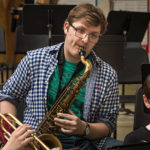 UW-River Falls music education student Kyle Punt, center, practices with Meyer Middle School sixth graders Claire Vaught, left, and Max Pnewski, right, during an afternoon Harmony Bridge session.