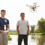 Photo of UW-La Crosse student Zachary Woodcock, left, who earned a summer research grant to use drones to conduct aerial surveys of purple loosestrife, an aquatic invasive plant with help from UWL faculty mentor and remote sensing scientist, Niti Mishra, right. Here Woodcock takes a drone survey test flight at the La Crosse River Delta near Bangor, Wisconsin.