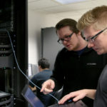 Photo of UW-Stout students Pierce Lannue, left, and Stephen Felton, who are working in a computer networking and information technology lab in October in Fryklund Hall. UW-Stout has been named a national Center of Academic Excellence in Cyber Defense.