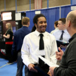 Photo of Jalen Hendley, a computer science-game design major from Flossmoor, Ill., visiting with a recruiter at a 2017 Career Conference. / UW-Stout photo by Brett Roseman