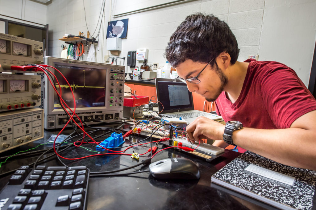 Photo of UW-River Falls physics major Roman Alvarado is conducting ground-breaking robotics research that could change the lives of amputees around the world.