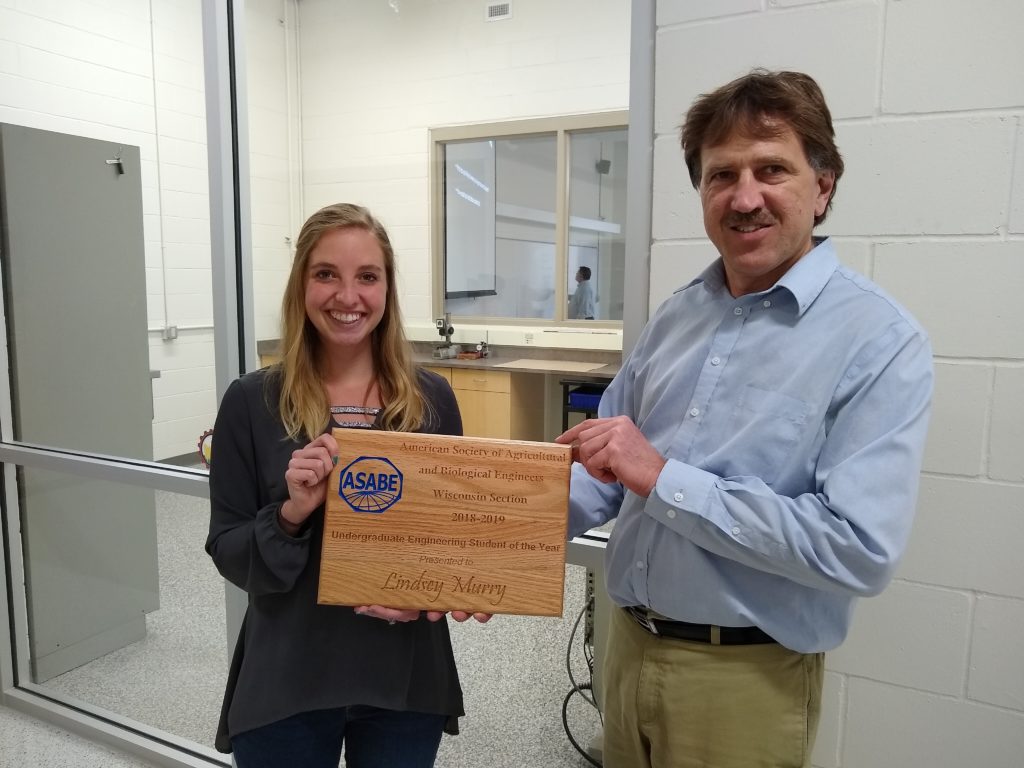 Photo of Joe Shakal, chair of the Agricultural Engineering Technology Department at UW-River Falls, presenting senior Lindsey Murry with the 2019 ASABE Agricultural Engineering Undergraduate Student of the Year Award.