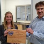 Photo of Joe Shakal, chair of the Agricultural Engineering Technology Department at UW-River Falls, presenting senior Lindsey Murry with the 2019 ASABE Agricultural Engineering Undergraduate Student of the Year Award.
