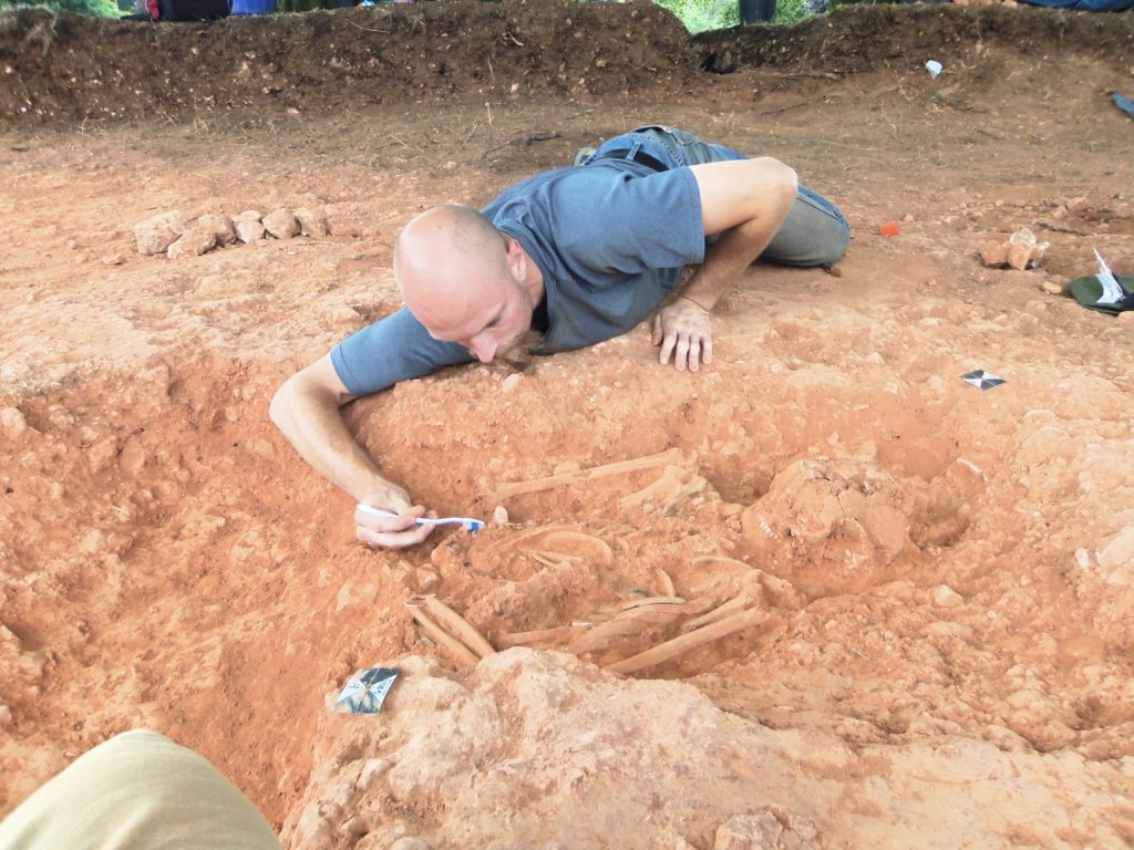 Photo of UW-Whitewater student Cameron Cudnohowski, who unearthed three 1,000-year-old Anglo-Saxon skeletons on an archeological dig in England. Cudnohowski, a future teacher, said, “You study history in books, but this experience – literally putting the pieces of these people together and searching for their story – brings history alive.”