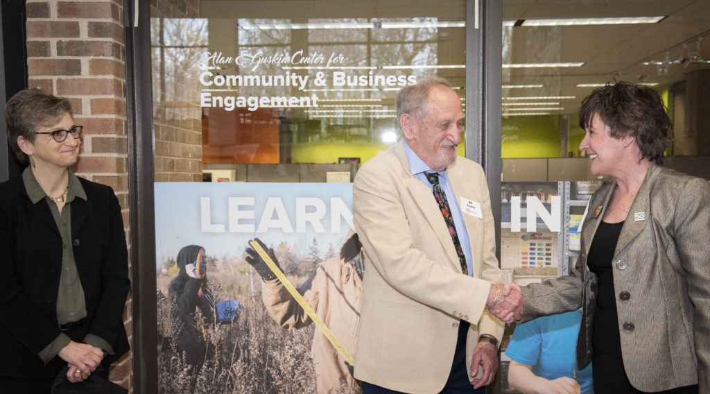 Photo of Dr. Alan Guskin, UW-Parkside's second chancellor, shaking hands with Dr. Debbie Ford, UW-Parkside's current chancellor