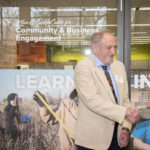 Photo of Dr. Alan Guskin, UW-Parkside's second chancellor, shaking hands with Dr. Debbie Ford, UW-Parkside's current chancellor