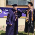 Photo of Chancellor Bernie Patterson and a 2020 spring graduate giving a congratulatory elbow bump