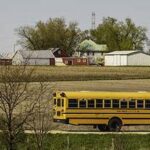 Photo of school bus traveling through rural area