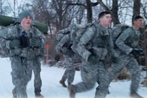 Photo of Douglas Machkovech (left) running during an Army ROTC competition hosted by UW-La Crosse at Grandad Bluff Park. The competition involves cadets moving through snow in winter conditions to complete various individual and team tasks. (Photo courtesy of Douglas Machkovech)
