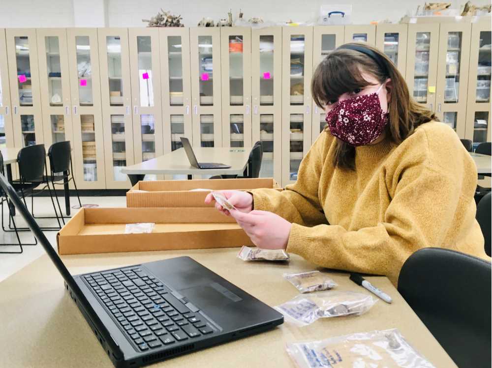 Photo of UWL student Faith Kalvig working on documenting archaeological materials as part of a historical archaeology class that has worked to preserve the heritage and history of the Red Cliff Band of Lake Superior Chippewa, one of Wisconsin’s 11 Native American nations