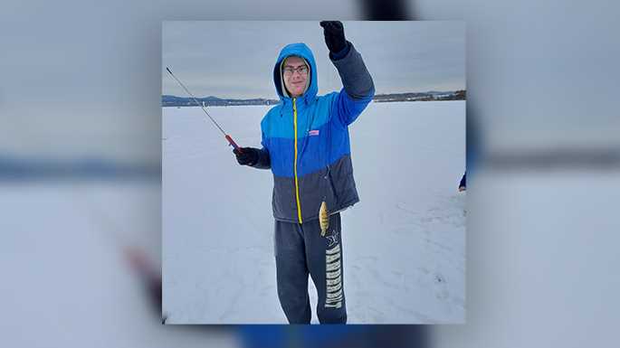 Photo of member Jacob Dunnum proudly showing the first catch of the day for the Ice-Fish-A-Thon 2021 on Lake Onalaska. Eight UW-La Crosse Sigma Tau Gamma members raised $3,610 for Special Olympics.