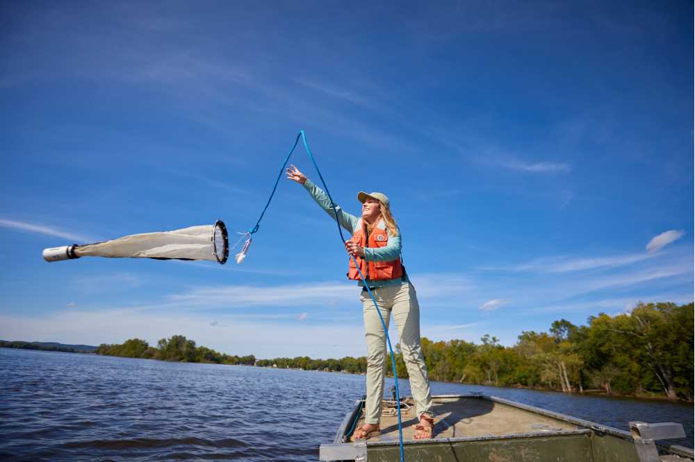 Photo of UW-La Crosse grad student Courtney Baker investigating microplastics in the Mississippi River in this 2019 photo. Through the Freshwater Collaborative, UWL students and faculty will continue to be global leaders in freshwater science and critical aquatic issues.