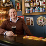 Photo of John Harry, whose interest in beer antiques and memorabilia led him to choose beer history as the focus of his studies at UWM. (UWM Photo/Troye Fox)