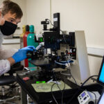 Photo of Eliot Driessen conducting research in the nano lab.