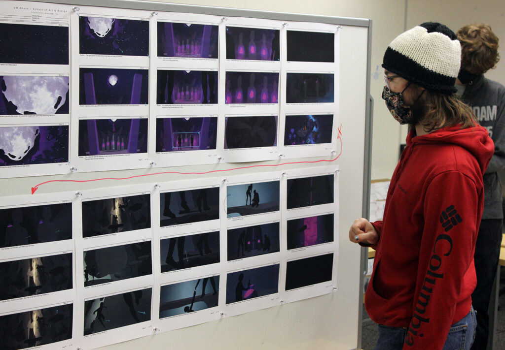 Photo of student Jonah Hammen studying a storyboard in the Animation Production class. / UW-Stout photo