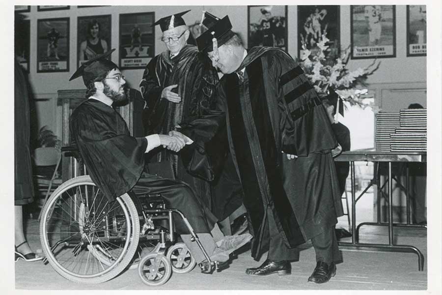 Photo of Chancellor James R. Connor, right, congratulating a student at commencement.