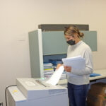 Photo of UW-Stout student Heather Kent, a senior business administration major from Altoona, shredding office paper in the Human Resources office./UW-Stout photo