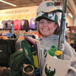 Photo of Alumni Director Kari Moody loads-up on Phoenix pride items from The Phoenix Bookstore.